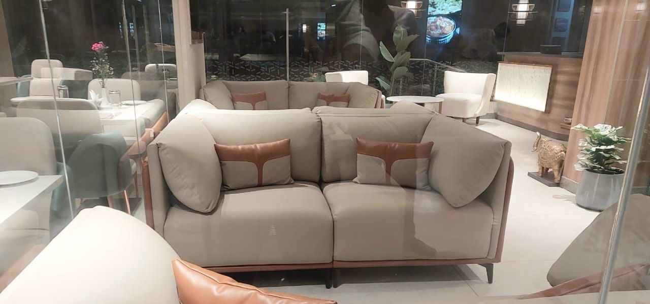 A lobby at Hotel Raai, Hosur featuring seat area with sofa sets and centre tables.