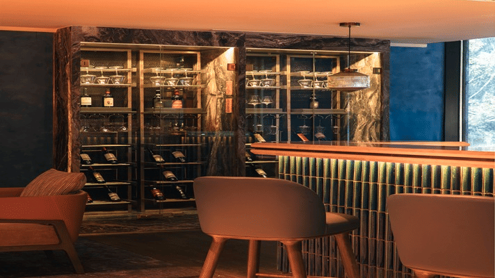 Stylish bar interior with warm lighting and seating at The Residency Towers Chennai.