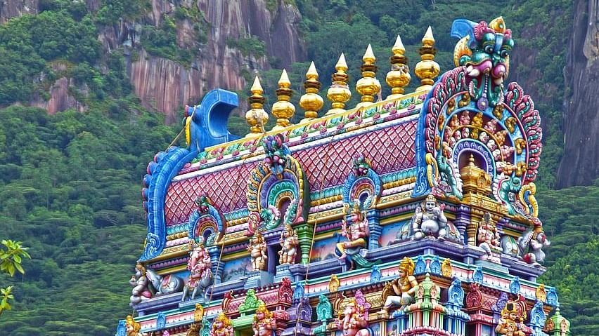 Vibrant, multi-coloured temple tower adorned with intricate carvings.
