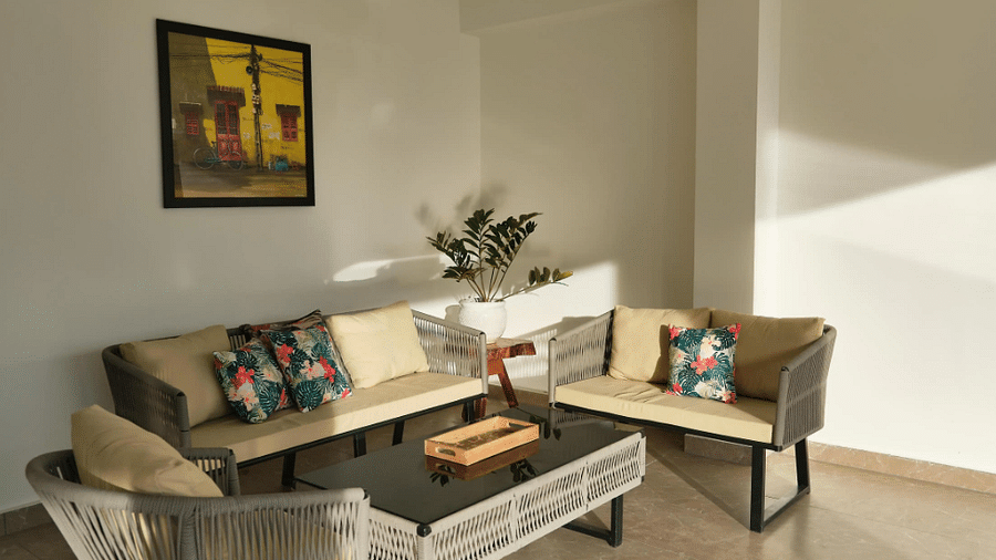Well-decorated living room featuring a sofa, chairs, a table, and artwork. - VITS Kunjham Retreat, Gangtok