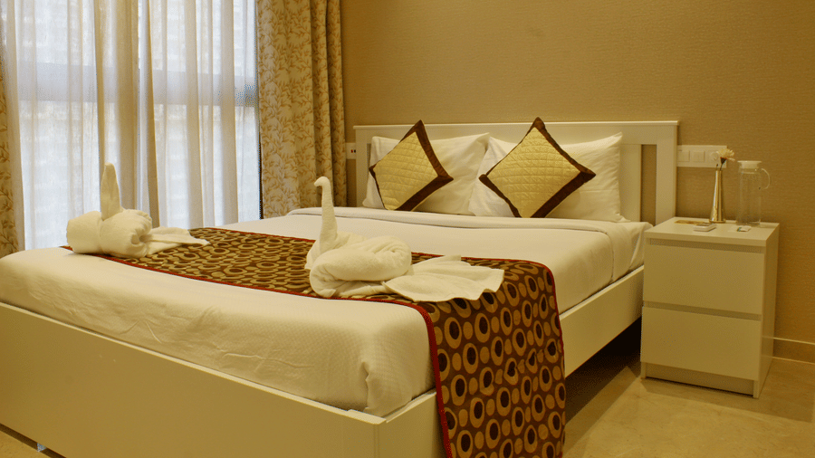 Side view of the bedroom with plush bed side table and modern interior - Maxxvalue Apartment, Hiranandani, Powai