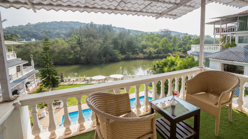 The chairs and teapoy at the balcony - Stone Wood Riverfront Resort, Siolim