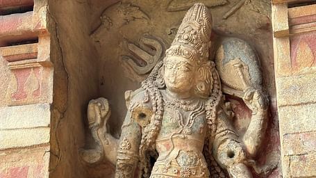 Intricate statue carved into the wall, showcasing detailed craftsmanship and artistic expression of the region's heritage.