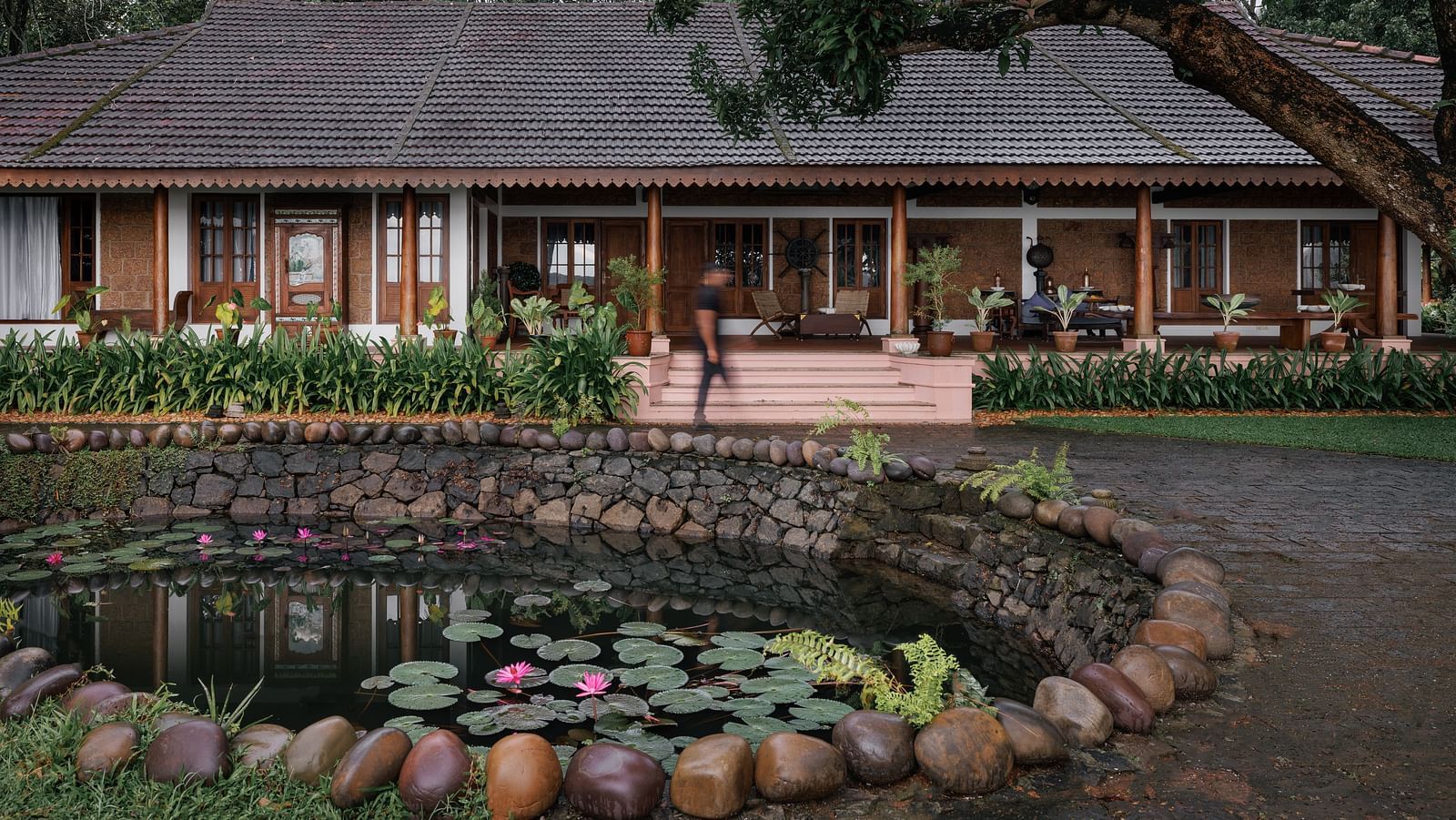 A facade image of BluSalzz Villas - Muhamma Resort, Alleppey with a pond in front of the resort