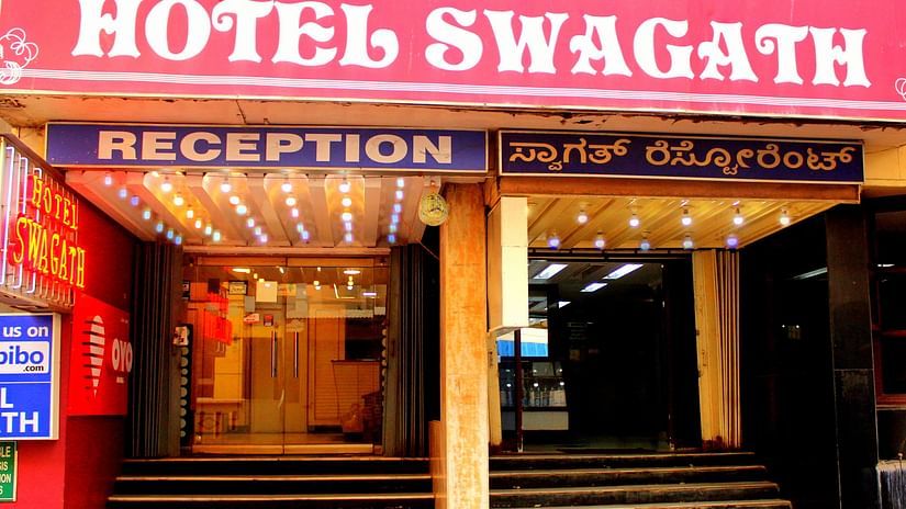 A warmly lit entrance to Hotel Swagath, Bangalore