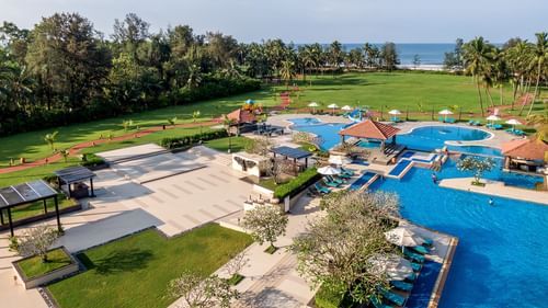 An aerial exterior shot of Kenilworth Resort & Spa, Goa featuring a vast swimming pool