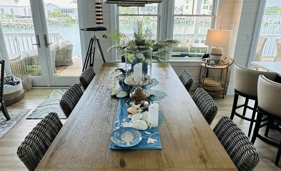 A view of a dining area wit a long wooden table and multiple chairs at Elbow Room Villa 7 in Abaco inn 