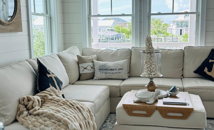 The living area of Elbow Room Villa 7 in  Abaco inn with multi seating sofa, a large window and patterned rug