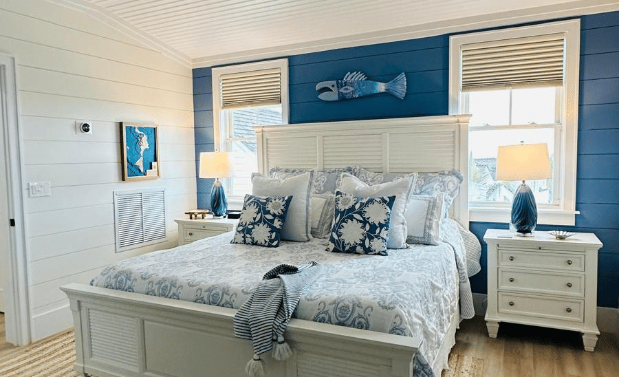 A wide view of a bedroom featuring a double bed, 2 side table, ceiling fan, and 2 windows at Elbow Room Villa 7 in  Abaco inn