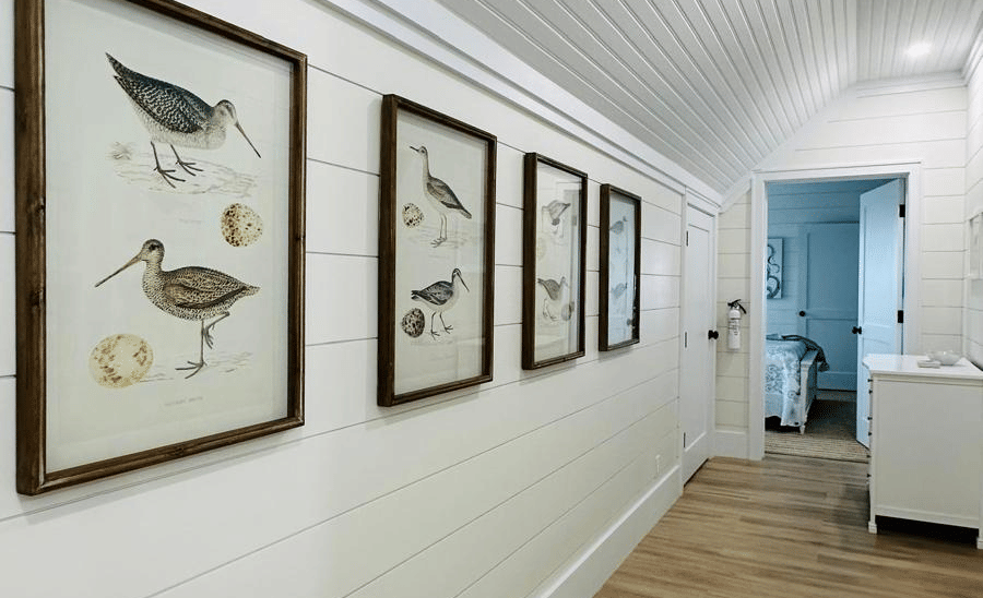 A view of a lobby at Elbow Room Villa 7 in  Abaco inn with multiple framed paintings mounted on the wall