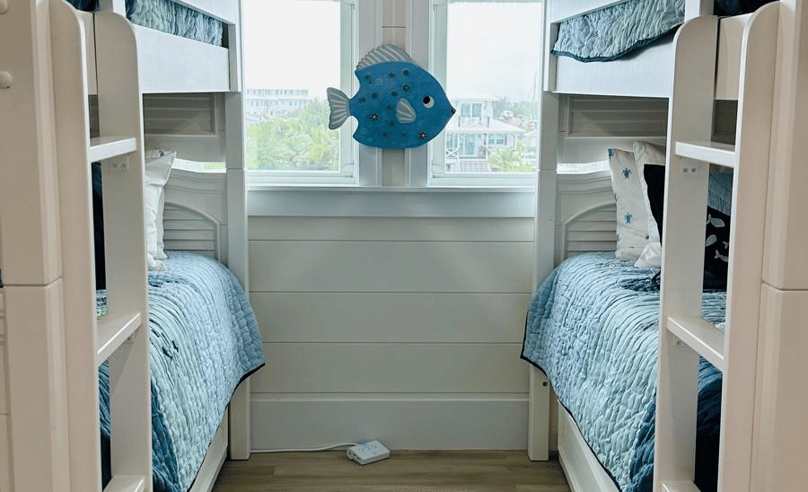 A view of a bedrooom with twin bunk bed and a large window at Elbow Room Villa 7 in  Abaco inn