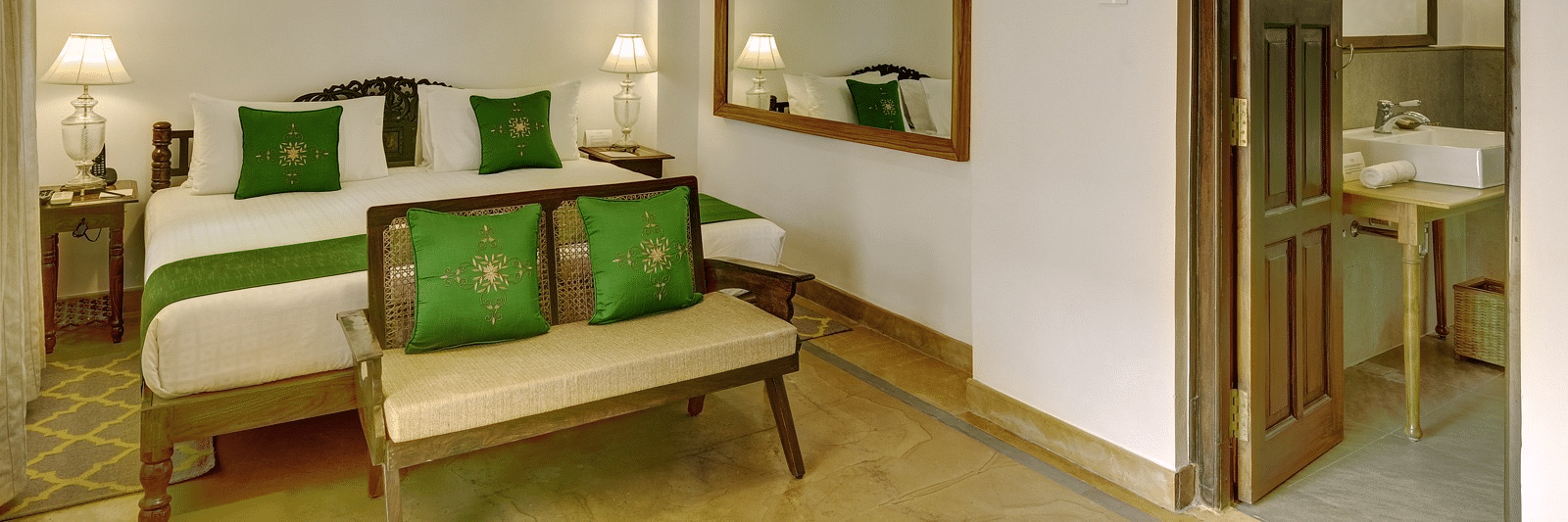 Awadh Room with a double bed and seating at Saraca Hotel, Lucknow