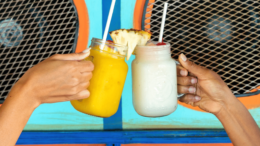 An image of people clicking their drinks - S Hotel Montego Bay, Jamaica