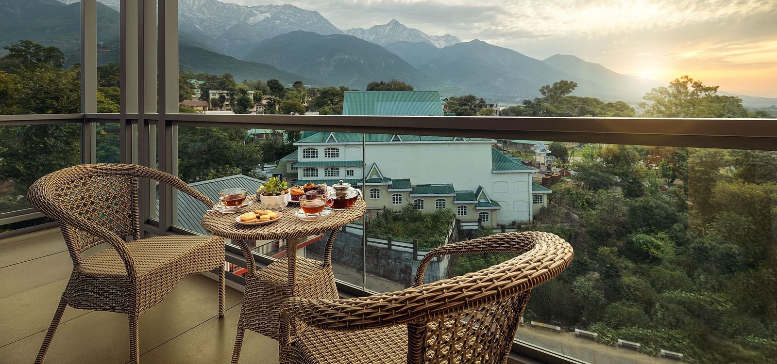Premium peaks balcony area with a coffee table and chairs with mountains in the backdrop