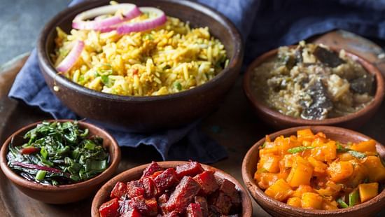Traditional Himachali thali with rice, vegetables, and side dishes.