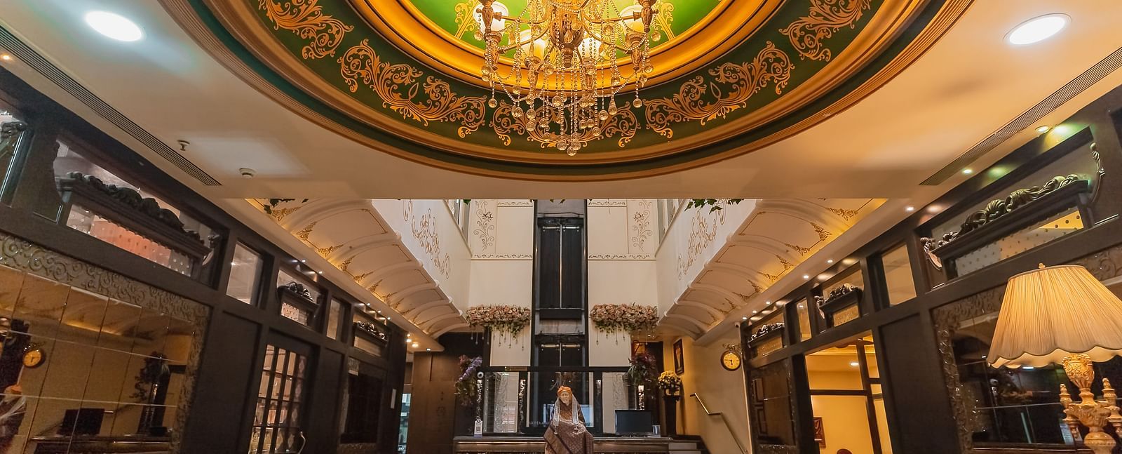 Hotel Ashok Nagpur featuring a well-lit lobby with dark wood accents, plush seating, and a reception area.