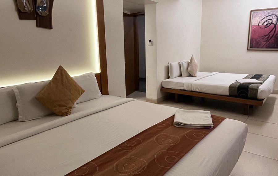 View of Family Room in Astra Hotels and Suites, HSR Sector 1 where two beds are placed in a spacious room.