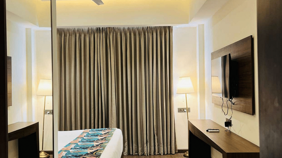 entry to comfort room with a king sized bed and TV at Aura Boutique Hotel, Udaipur