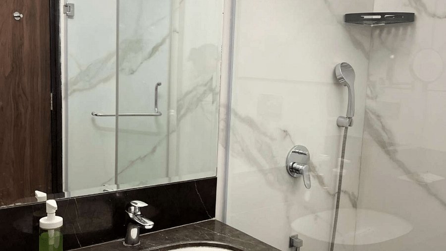 a view of the washroom with wash basin and shower facilities of comfort room at Aura Boutique Hotel, Udaipur