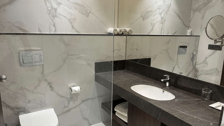 a view of the washroom with wash basin and shower facilities of  premium city view  room at Aura Boutique Hotel, Udaipur