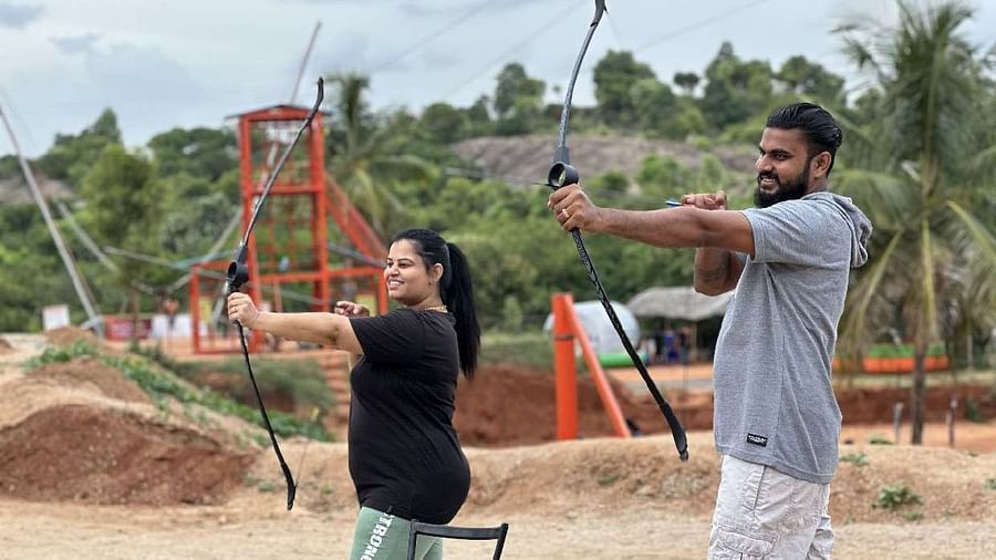 Two people with bows and arrows at Ravishing Retreat aiming