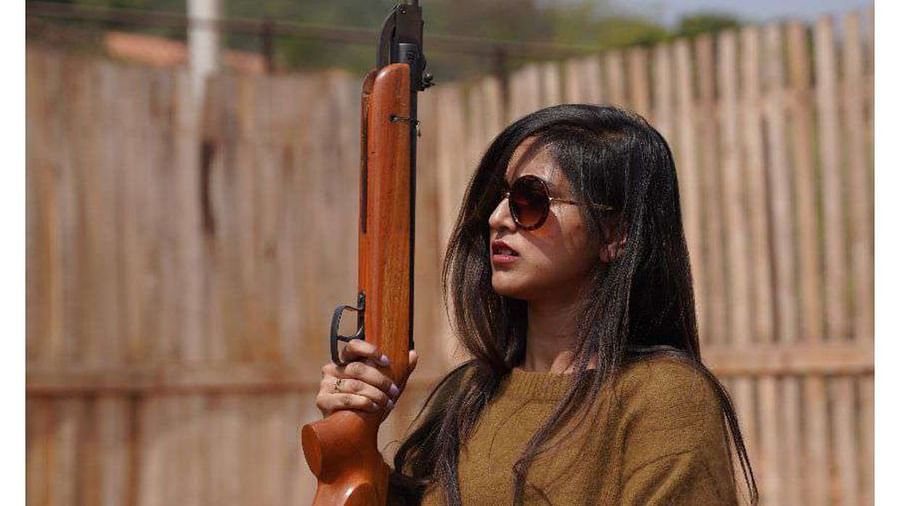 A woman holding a rifle for a shooting game at Ravishing Retreat 