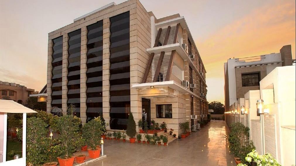 Exterior view of Five Elements Hotels The Claire, Gurugram, showcasing the modern facade and entrance area at sunset