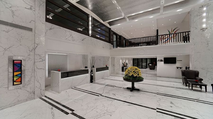 Indoor swimming pool in a contemporary setting with sleek walls and deck seating.