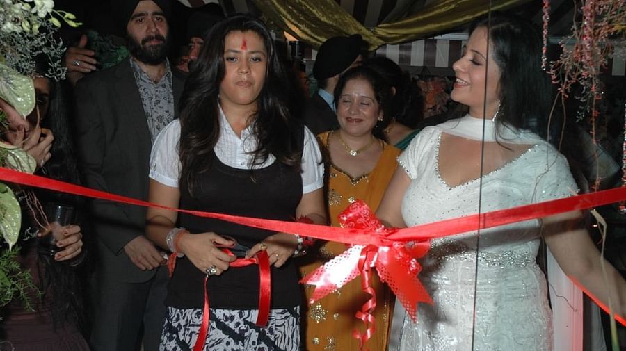 a celebrity cutting the ribbon during the opening of IOSIS Spa & Wellness