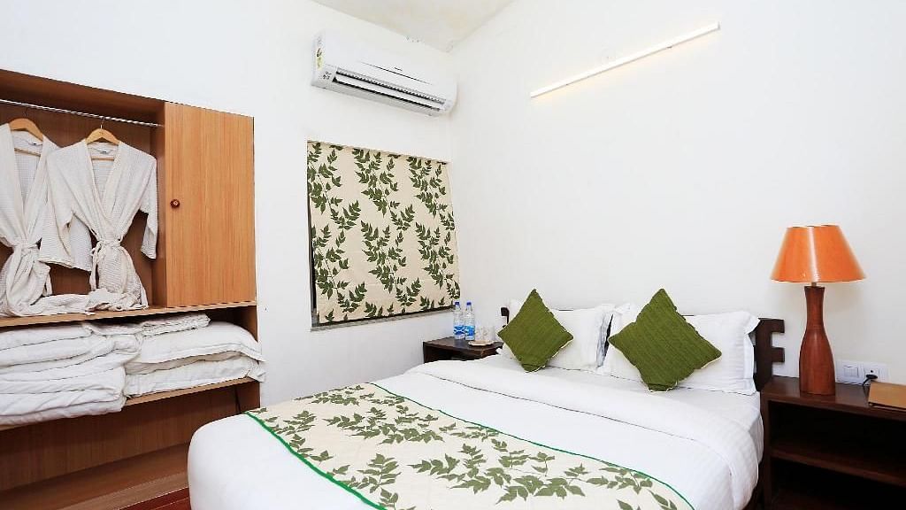 A plushy king size bed with a bedside table and a table lamp Meadows Bedroom