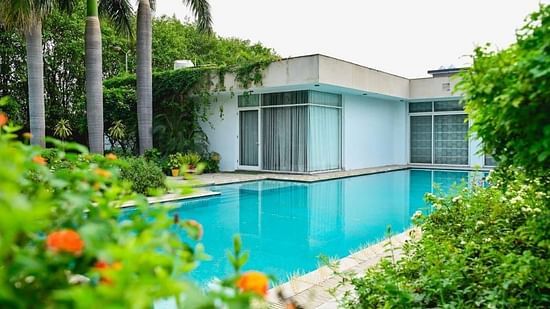Shot of the swimming pool at our villa with trees all around | Udman Luxe Villa