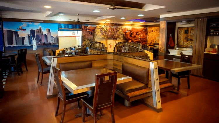 Picture of aroma resturant, featuring tables and chairs set for dining