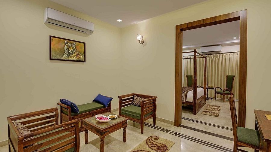 A living space featuring a wall painting, sofa chairs and a coffee table - Clarks Safari, Ranthambore
