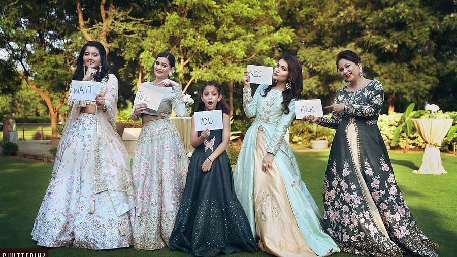 four women and a child holding placards and posing for a picture on the garden - Karma Lakelands.