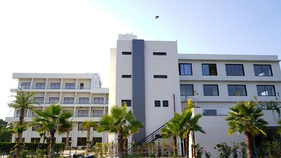 Pride Ranakpur Resort Convention Centre - exterior view of the property building with trees and grass present on the foreground