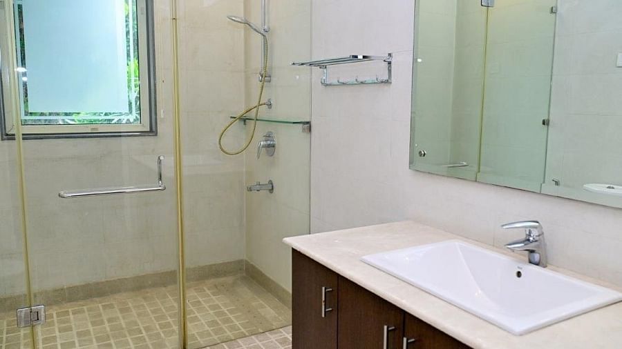 Shot of fully equipped washroom with a glass door that separates the shower area from the basin | Udman Luxe Villa