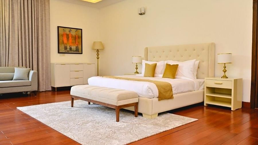 Shot of a pastel coloured themed room with a kind size bed, yellow pillows