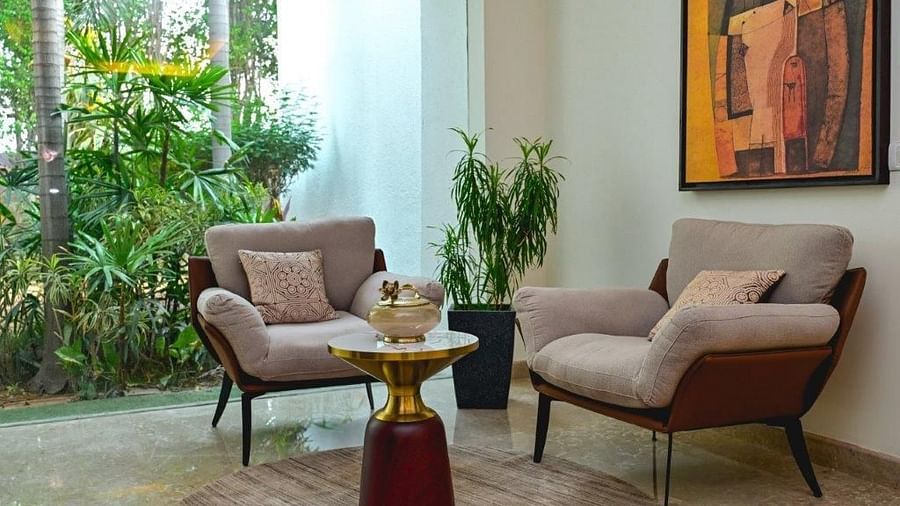 Shot of a cosy setup at the living room of the villa featuring two single setter couch and a small table | Udman Luxe Villa 