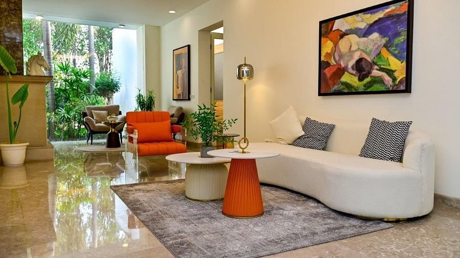 A wide angle shot of the living room at our villa featuring different sofa and couches on a carpeted floor and small tables | Udman Luxe Villa