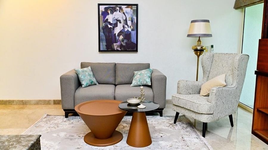 Shot of one single seater and one  a double seater couch with a round table at the centre  | Udman Luxe Villa