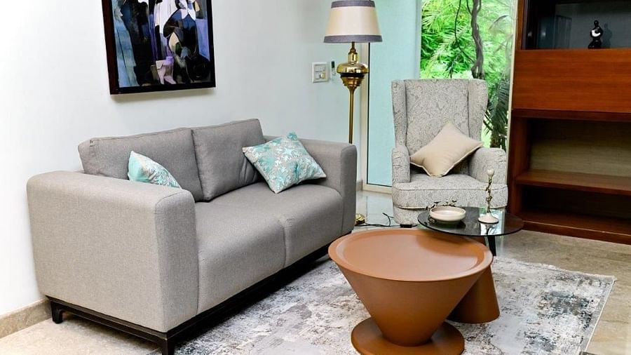 Shot of one single seater and one  a double seater couch with a round table at the centre  | Udman Luxe Villa