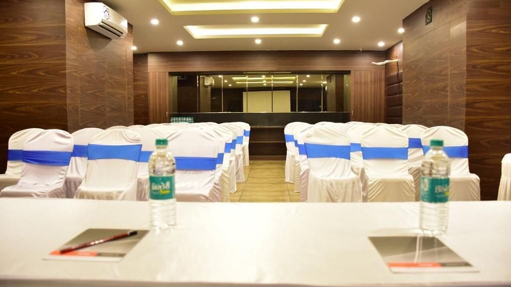 Image of a table with two water bottles and notepads placed on it with chairs in front at Calux Grand Baga.
