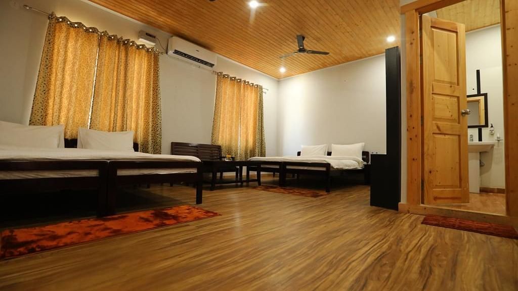 Family Room On Land bedroom closeup shot of clean linens and soft lighting of the room - Le ROI Floating Huts Eco Rooms2