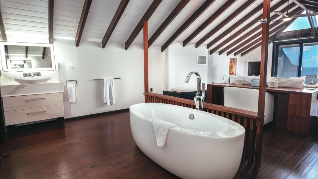 a bathtub and vanity area in the bathroom of beachcomber at tamarind hills resort and villas antigua