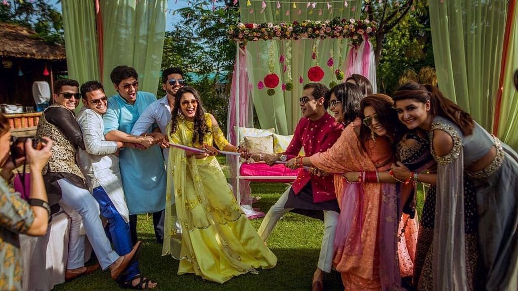 An image of two groups playing tug of war near a decorated stage