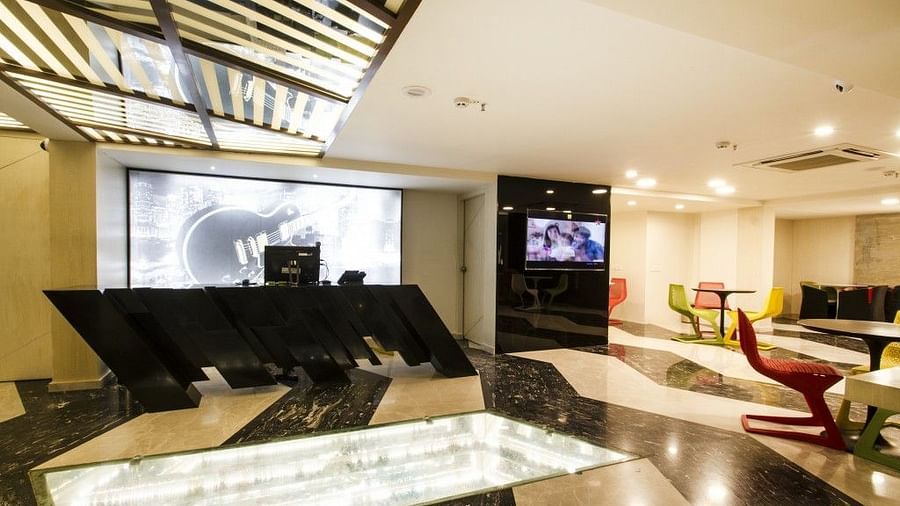 Reception area witha counter table and televion on the wall at Art Boutique Hotel, Hyderabad 