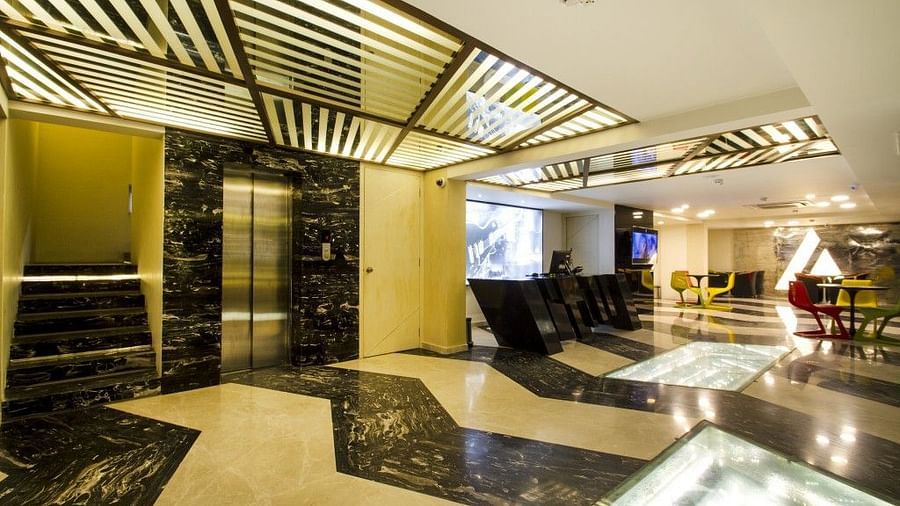 Reception area with lift and counter table at Art Boutique Hotel, Hyderabad