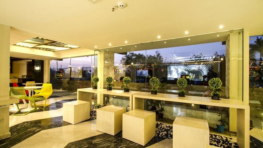 Reception area with seatig area and plants at Art Boutique Hotel, Hyderabad