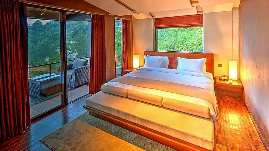 A cosy bedroom with warm lights and huge  windows  | Kavya Resort and Spa, Nagarkot