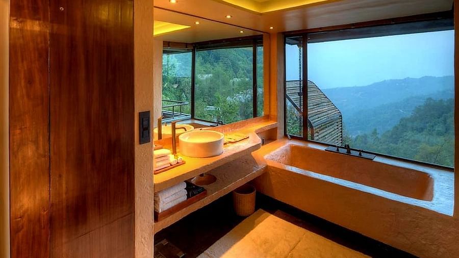 An outdoor view bathroom with a tub and mirror above the sink | Kavya Resort and Spa, Nagarkot